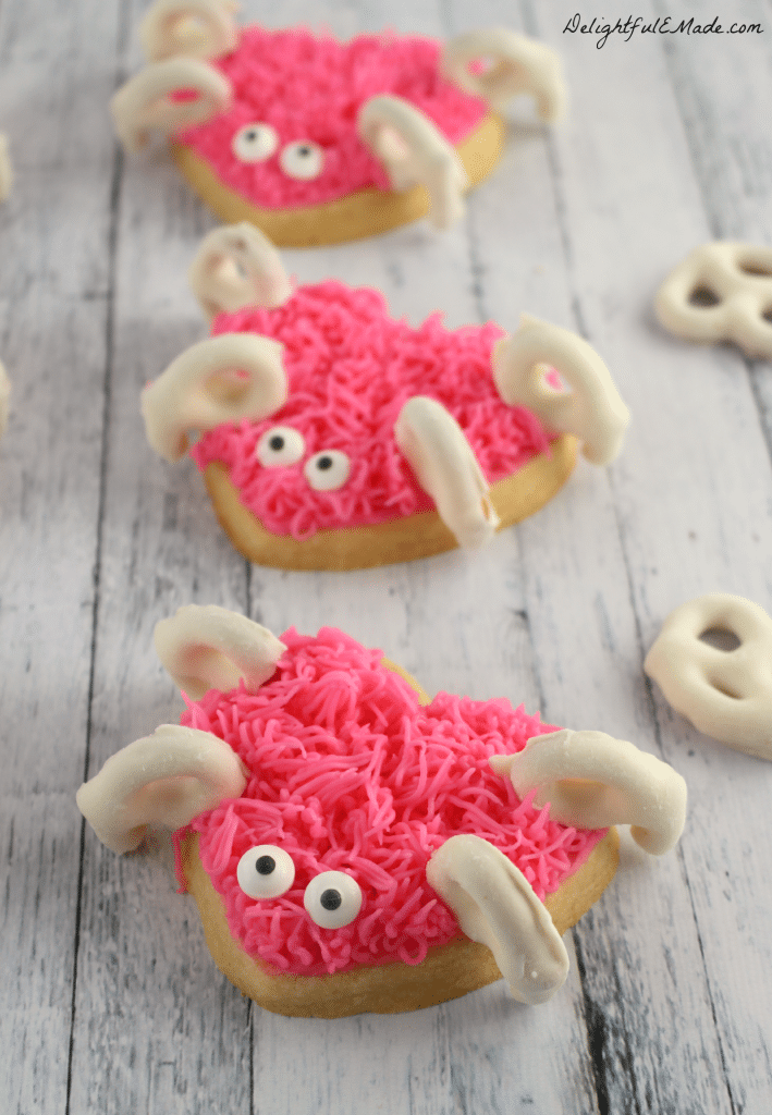 These adorable heart shaped sugar cookies are frosted with pink icing and decorated with yogurt covered pretzels to create these super-sweet Love Bugs! The perfect Valentine's Day treat!