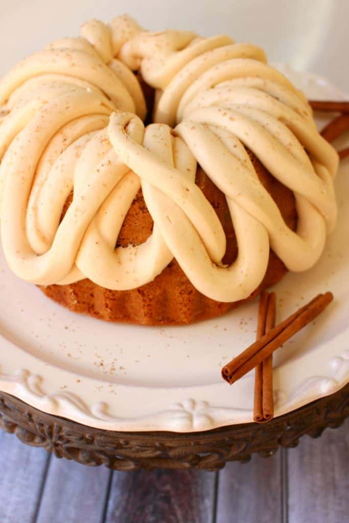 This amazing Apple Cider Cake recipe, topped with Caramel Cream Cheese Frosting is the perfect fall dessert! Made in a bundt pan, this fantastic apple cake will be a showstopper for any occasion!