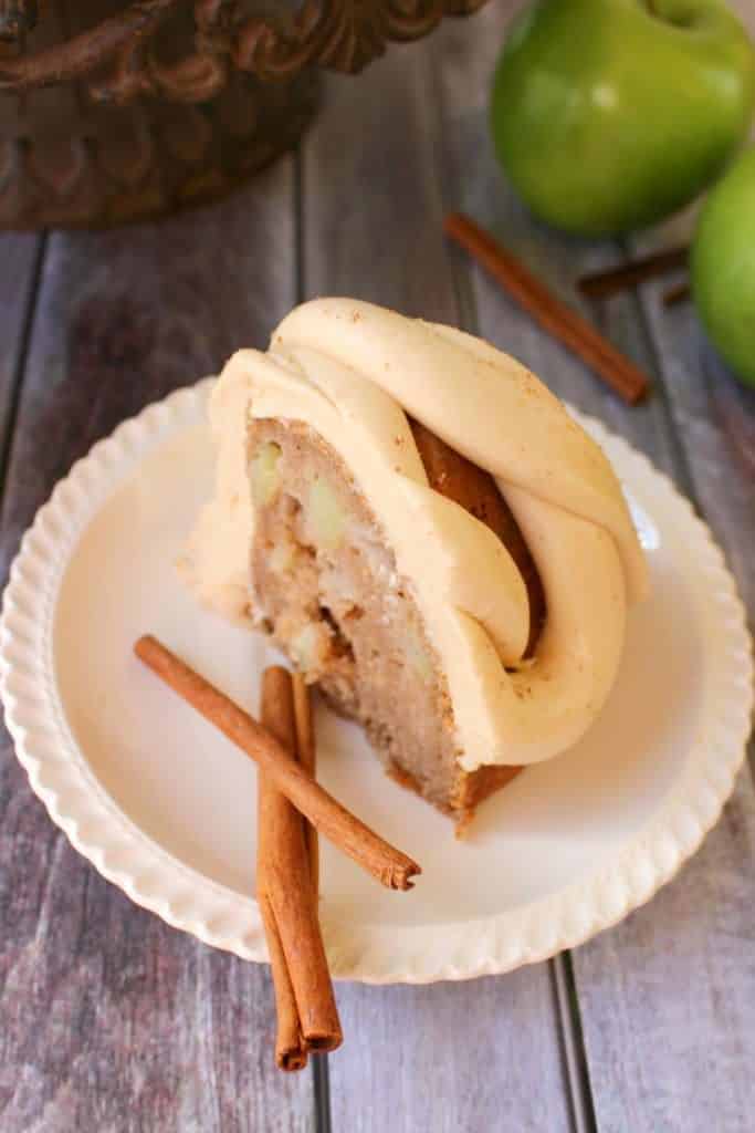 This amazing Apple Cider Cake recipe, topped with Caramel Cream Cheese Frosting is the perfect fall dessert! Made in a bundt pan, this fantastic apple cake will be a showstopper for any occasion!