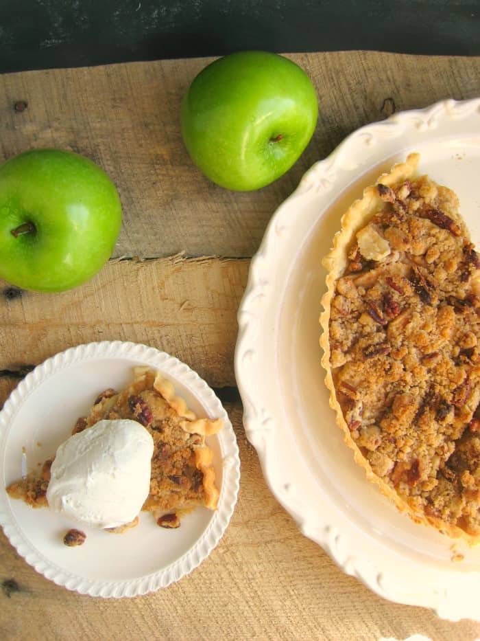 Easy as pie, this Dutch Apple Tart is an even easier version of the classic pie recipe! Sweet, tender apples, and a brown sugar cinnamon pecan crumble are baked to perfection making this tart a perfect addition to your holiday dessert table! Fantastic for Thanksgiving and Christmas dinner!