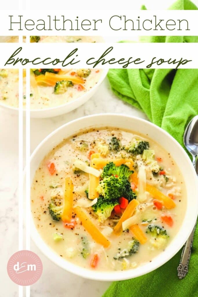 Two bowls of chicken broccoli cheese soup with green napkin and two spoons.