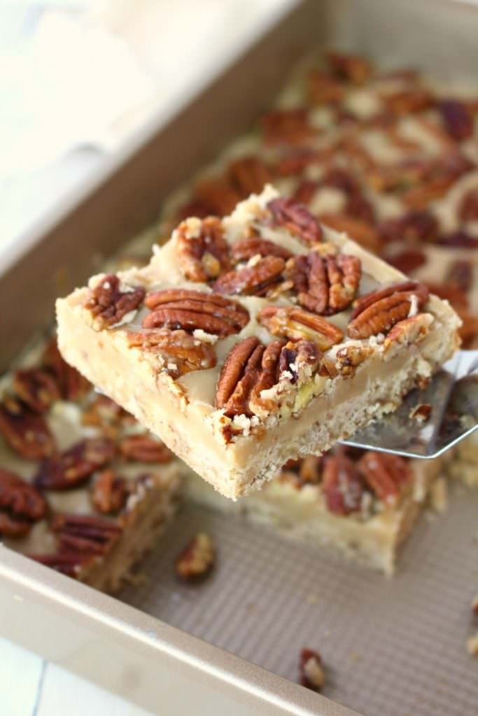 Cross between pecan pie and pecan sandies, these buttery, delicious Pecan Praline Bars are perfect any time you're in the mood for something sweet! An amazing pecan shortbread crust, a delicious caramel filling and topped with brown sugar toasted pecans, these bars are incredible! The perfect addition to your holiday cookie trays!