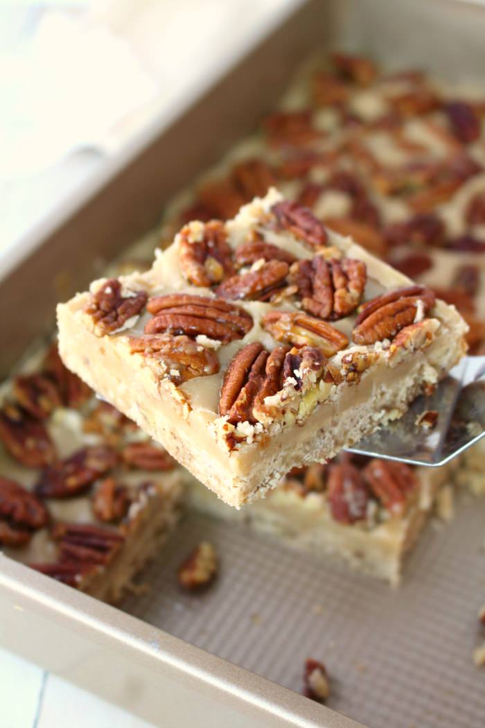 Cross between pecan pie and pecan sandies, these buttery, delicious Pecan Praline Bars are perfect any time you're in the mood for something sweet! An amazing pecan shortbread crust, a delicious brown sugar filling and topped with toasted pecans, these bars are incredible!