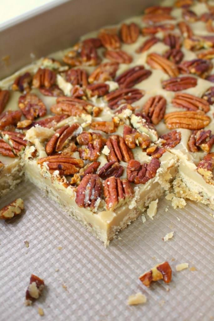 Cross between pecan pie and pecan sandies, these buttery, delicious Pecan Praline Bars are perfect any time you're in the mood for something sweet! An amazing pecan shortbread crust, a delicious caramel filling and topped with brown sugar toasted pecans, these bars are incredible! The perfect addition to your holiday cookie trays!