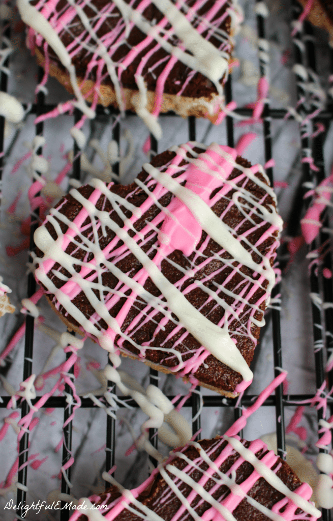 A dark chocolate layer tops a white chocolate layer, all topped with a candy drizzle.  Perfect for cutting into hearts or squares!