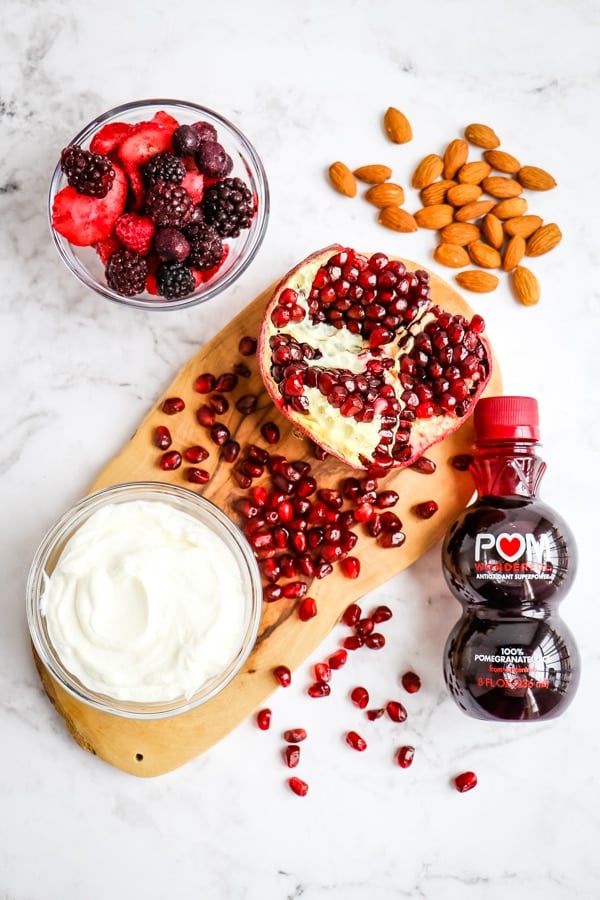 Ingredients needed to make a berry pomegranate smoothie recipe.