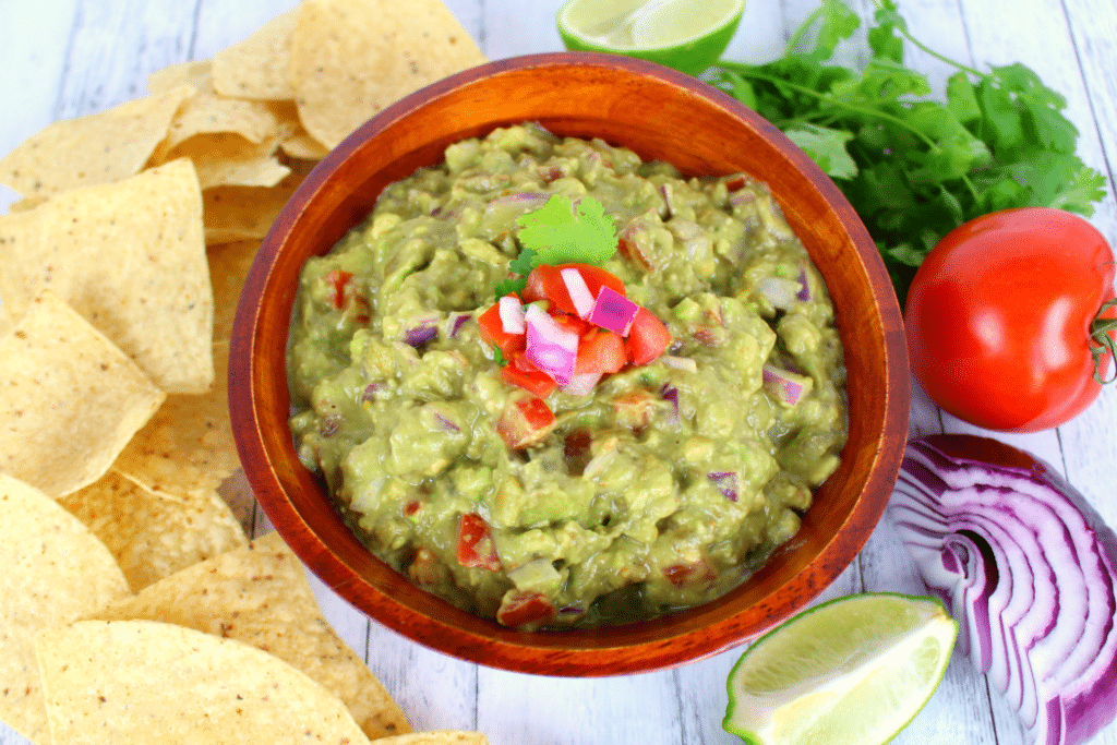 A must-have for any Mexican meal! This fresh, delicious chunky guacamole is loaded with fresh avocados, tomatoes, onions and the perfect spices.   You'll want to put this guacamole on everything!