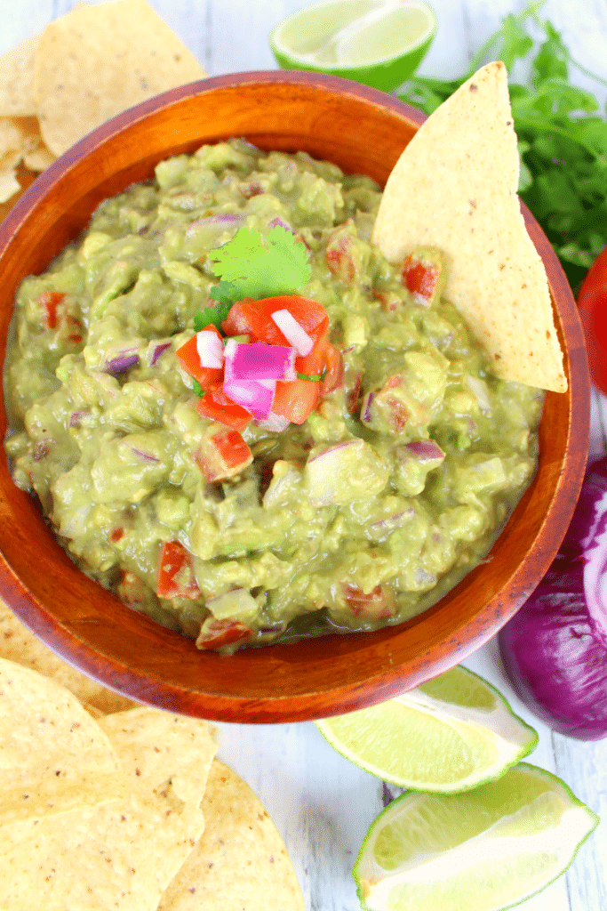 A must-have for any Mexican meal! This fresh, delicious chunky guacamole is loaded with fresh avocados, tomatoes, onions and the perfect spices.   You'll want to put this guacamole on everything!