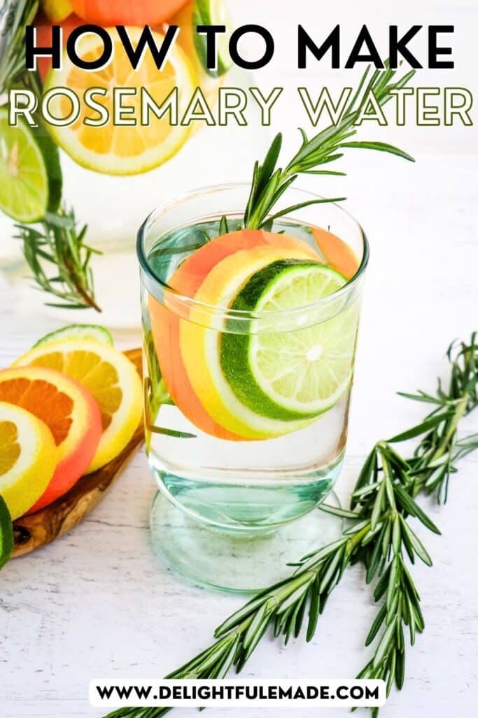 Glass of rosemary water with sliced lemon, lime and orange, with sprigs of rosemary on the side.