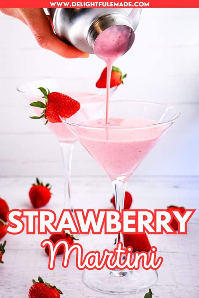 Strawberry martini being poured into a glass from a cocktail shaker.