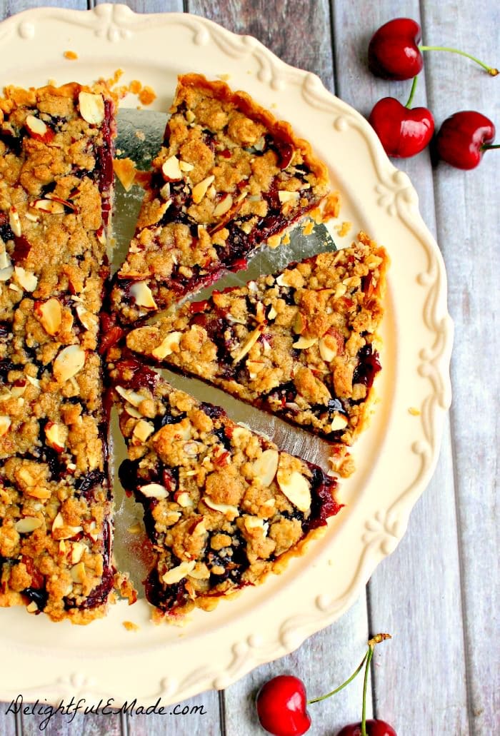 Even easier than Cherry Pie, this Cherry Almond Crumble Tart is fabulous! Loaded with fresh cherry flavor, this super-simple tart recipe, uses store-bought pie crust, along with fresh or frozen cherries. Makes an amazing Thanksgiving or Christmas dessert or just a simple weeknight treat!