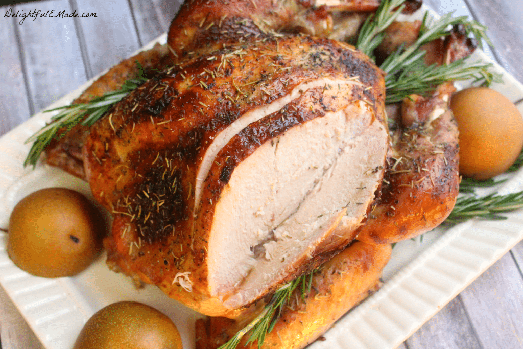 Roasted turkey with breast meat being carved.