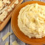 Perfectly creamy, these Parmesan Mashed Potatoes are nothing short of spectacular. Russet potatoes are lightly seasoned and combined with sour cream, cream cheese and Parmesan cheese making these potatoes the ultimate side dish for any meal! A must for every holiday meal as well!