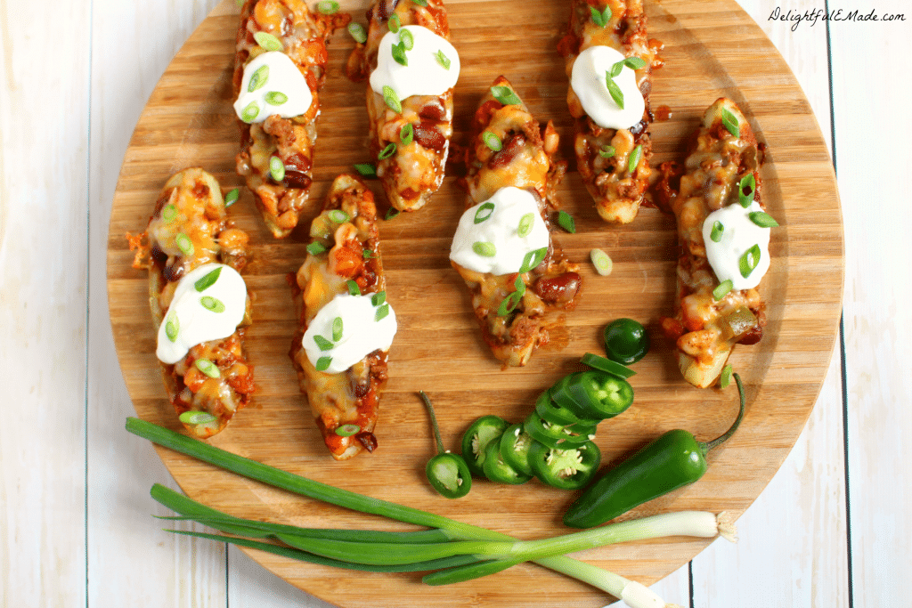 Not your ordinary appetizer! These Chili Cheese Potato Skins are loaded with thick, chunky chili, colby jack cheese, and sour cream and go great with an ice cold beer! 