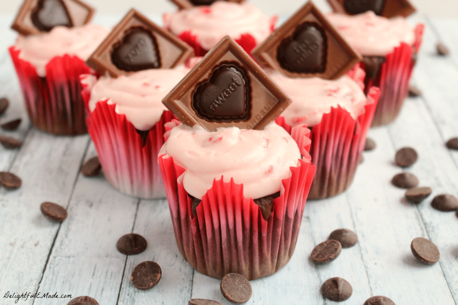 These decadent cupcakes start with a super moist, delicious chocolate cake, studded with Ghirardelli Premium Baking Chips, and topped with a strawberry cream cheese frosting and garnished with a beautiful Ghirardelli Valentine Impressions chocolate! Beautiful and delicious!