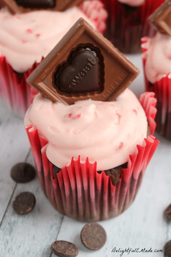 These decadent cupcakes start with a super moist, delicious chocolate cake, studded with Ghirardelli Premium Baking Chips, and topped with a strawberry cream cheese frosting and garnished with a beautiful Ghirardelli Valentine Impressions chocolate! Beautiful and delicious!