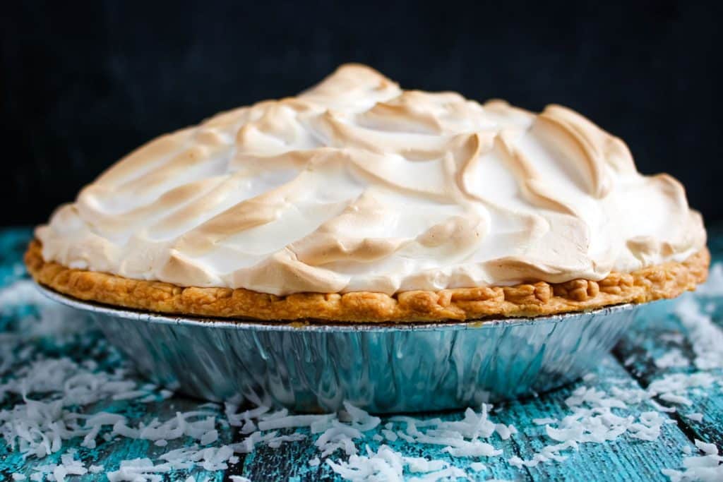 Side image of coconut cream pie with lightly browned meringue topping.