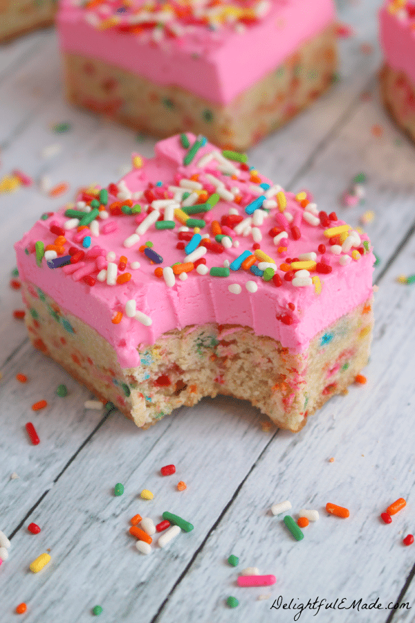 One of the BEST cookie bar recipes!  These thick, chewy frosted sugar cookie bars are loaded with sprinkles and topped with a thick layer of rich butter cream frosting. Every sprinkle lovers dream!