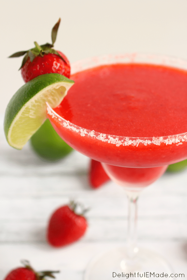 Bust out the tequila, its time for a Margarita! Blended with frozen strawberries, lime juice, and rimmed with salt, these frozen margaritas are easy to make, wonderfully refreshing and an all-time favorite cocktail!