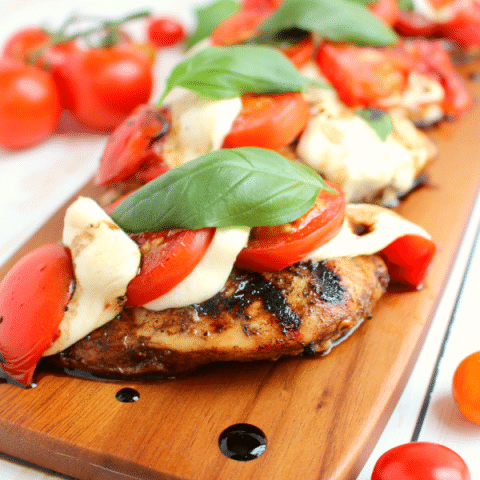 One seriously amazing grilled chicken recipe! Fresh tomatoes, basil and mozzarella top these balsamic vinaigrette marinated chicken breast, and grilled to perfection. Done and on the table in 20 minutes! Perfecto!!