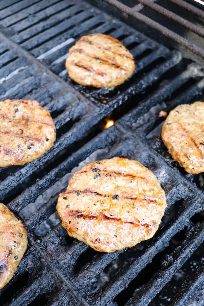 Burger patties being cooked on the grill.