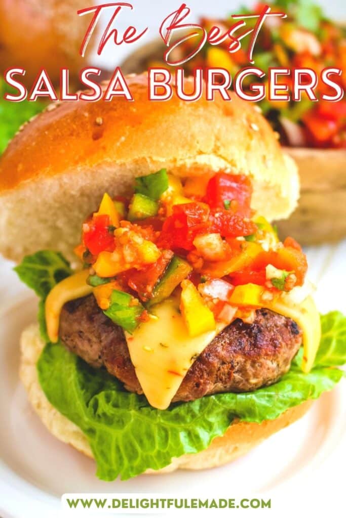 A salsa burger on a plate, topped with chunky salsa and pepper jack cheese on a sesame bun.