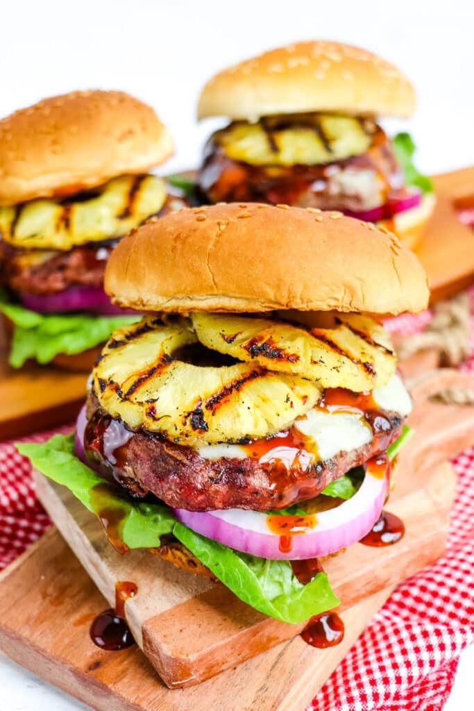 Pineapple burger topped with toasted sesame bun, grilled pineapple slices and teriyaki sauce.