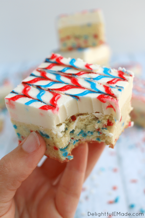 Lets celebrate America with these yummy, patriotic sugar cookie bars! The best sugar cookie recipe made into a bar, frosted with lots of delicious buttercream, and decorated with simple store-bought gel frosting, these cookie bars will be the hit of your July 4th picnic this summer!