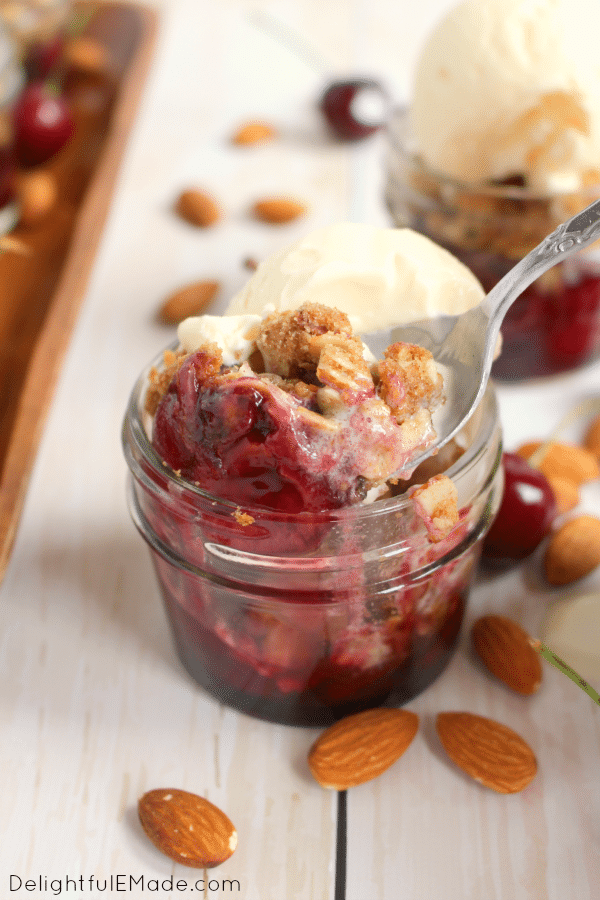 A dessert classic everyone loves!  Fresh cherries are topped with a delicious almond crisp and baked in jars for the perfect single-serving dessert.  Served fresh out of the oven with scoop of ice cream, these are incredible!