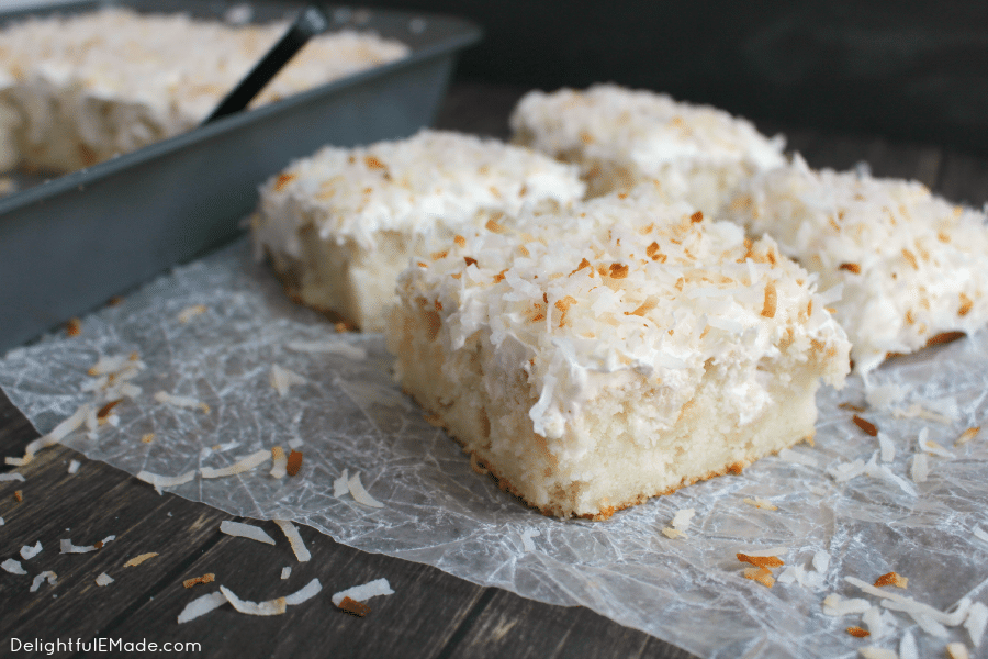 A dreamy, delicious coconut cake that will have you coming back for seconds!  This Coconut Cream Poke Cake uses a simple white cake mix, then topped with cream of coconut, coconut whipped topping and sprinkled with toasted coconut for the ultimate coconut cake recipe!