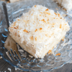 A dreamy, delicious coconut cake that will have you coming back for seconds! Creme of coconut is baked into a fluffy white cake making it super moist. The cake is then topped with coconut whipped cream and toasted coconut for the ultimate coconut treat!