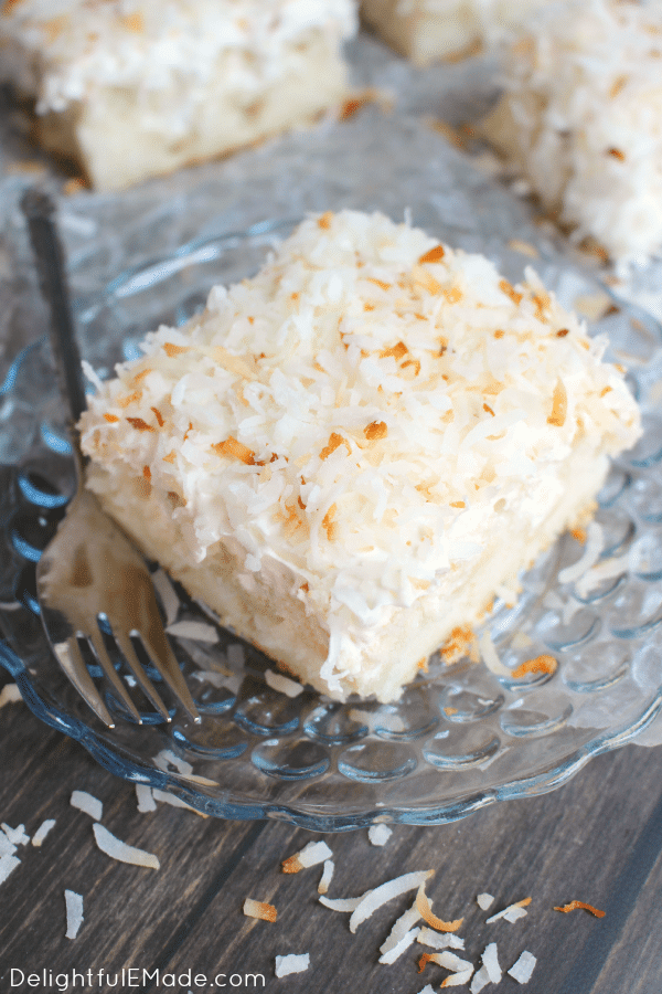 A dreamy, delicious coconut cake that will have you coming back for seconds!  This Coconut Cream Poke Cake uses a simple white cake mix, then topped with cream of coconut, coconut whipped topping and sprinkled with toasted coconut for the ultimate coconut cake recipe!