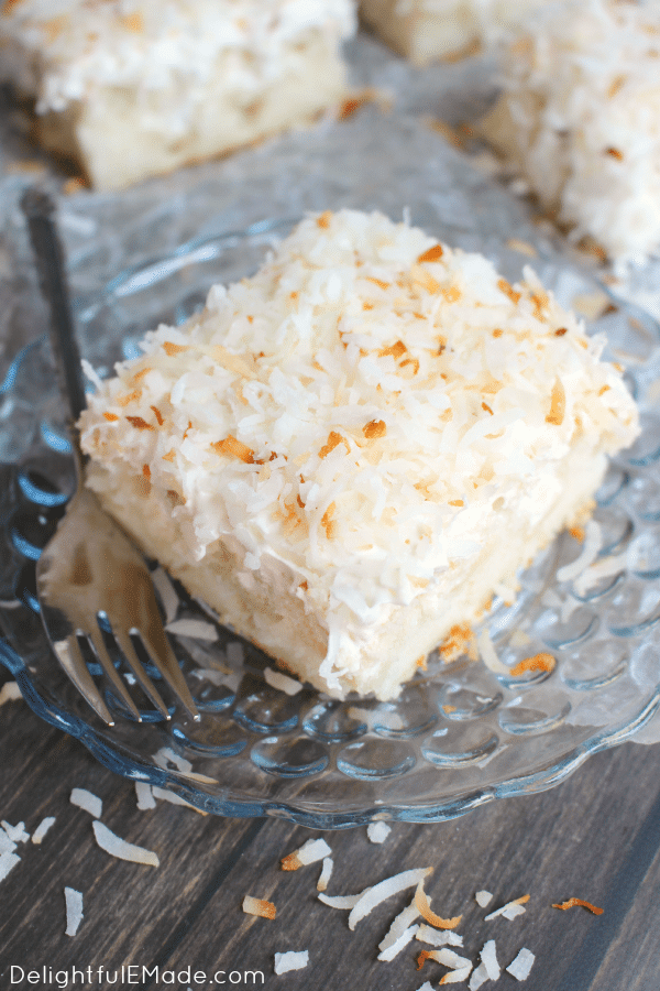 A dreamy, delicious coconut cake that will have you coming back for seconds! Creme of coconut is baked into a fluffy white cake making it super moist. The cake is then topped with coconut whipped cream and toasted coconut for the ultimate coconut treat!