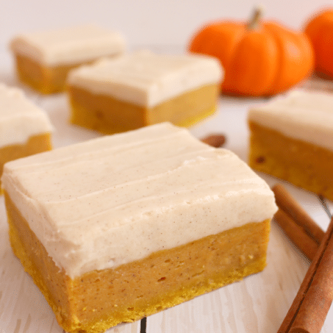 Sugar Cookie Bars with a delicious fall twist! Cinnamon cream cheese frosting tops these wonderfully chewy, delicious pumpkin spice treats! Pairs perfectly with the fall favorite pumpkin spice latte!