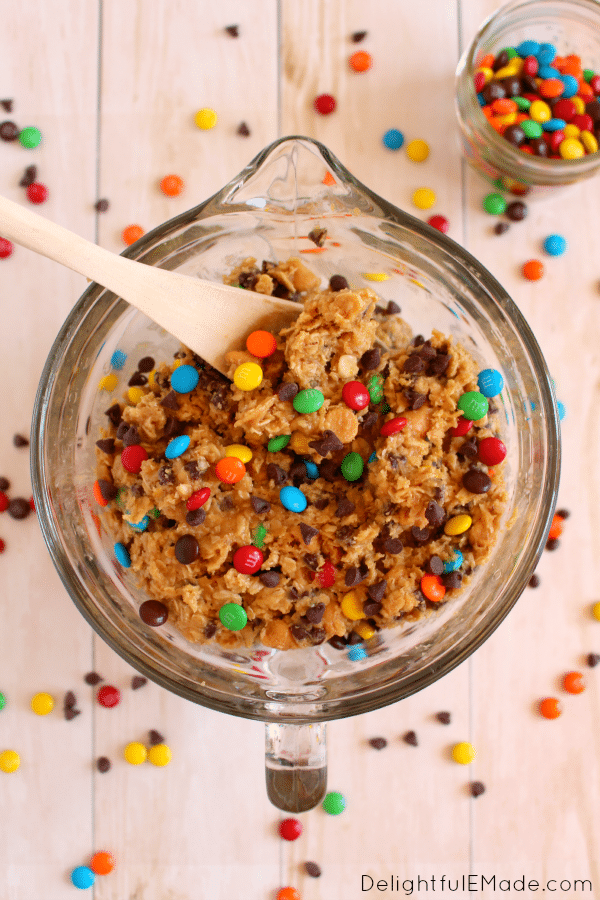 Monster Cookie Dough Bites | Loaded with M&M's, chocolate and peanut butter chips, this cookie dough is egg-free and made to be eaten right out of the bowl, or rolled into balls for the perfect cookie dough treat. No sneaking necessary! 