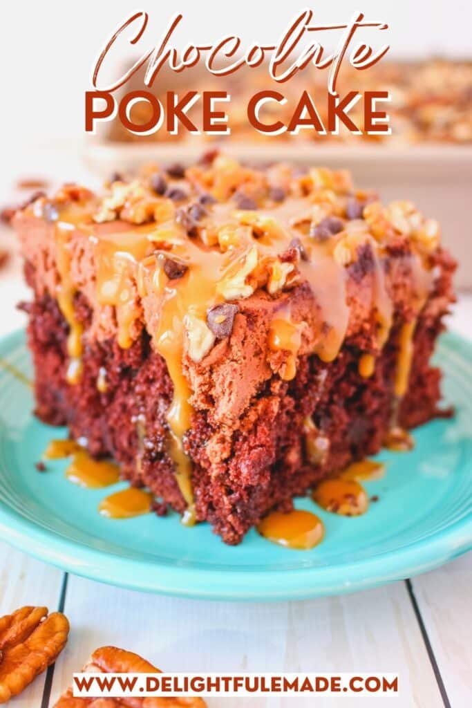 Slice of chocolate poke cake topped with chopped pecans, caramel sauce and mini chocolate chips.