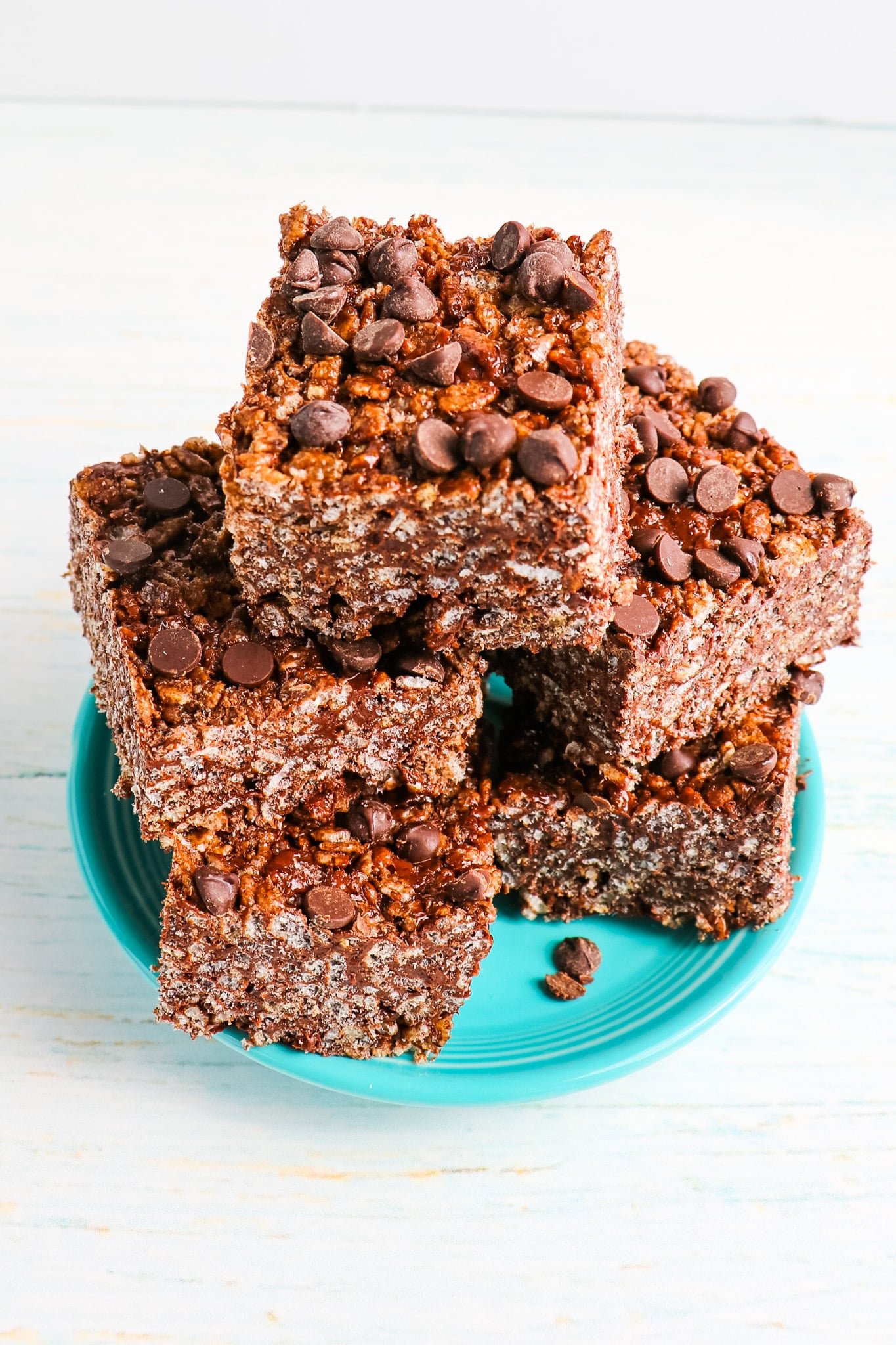 Chocolate rice krispie treats cut into squares on a plate.