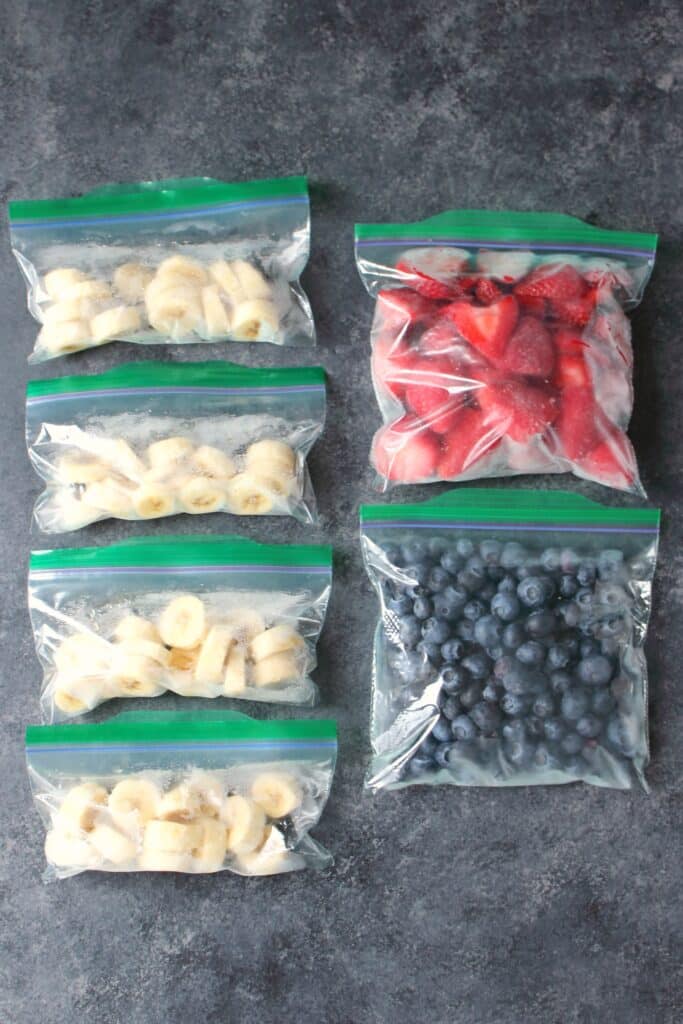 Frozen bananas, strawberries, blueberries in freezer bags.