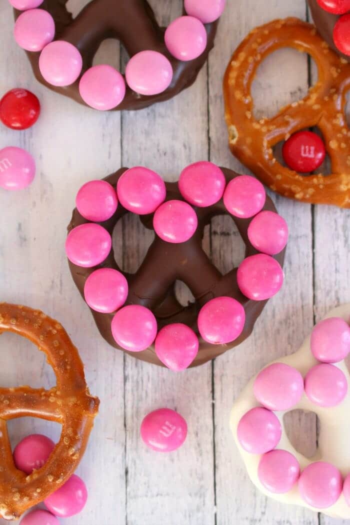 The ultimate salty-sweet treat for your Valentines!  These simple, homemade heart shaped chocolate covered pretzels are easy to make with just a few simple ingredients.  Decorated with M&M's® Strawberry candies, these jumbo pretzels make for the sweetest surprise for your sweethearts!