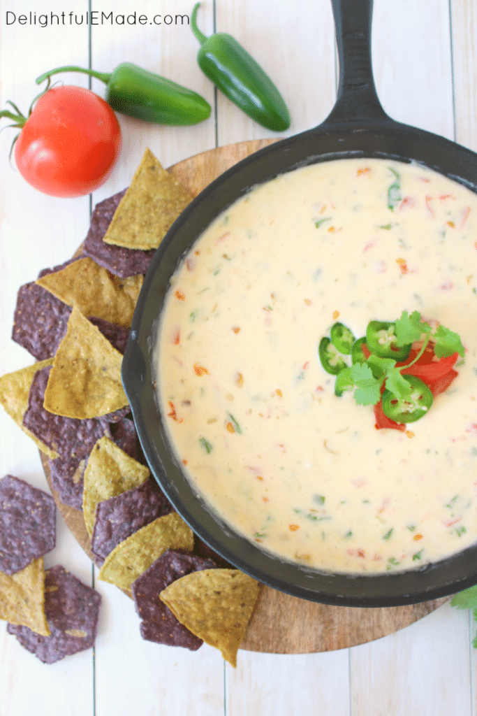 This hot, cheesy dip is perfect for game day! Loaded with two types of cheese, along with fresh tomatoes, jalapenos, and onions, this restaurant-style queso is the perfect appetizer anytime you want a great snack!