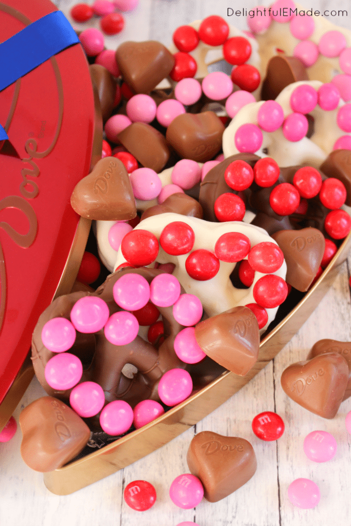 The ultimate salty-sweet treat for your Valentines!  These simple, homemade heart shaped chocolate covered pretzels are easy to make with just a few simple ingredients.  Decorated with M&M's® Strawberry candies, these jumbo pretzels make for the sweetest surprise for your sweethearts!