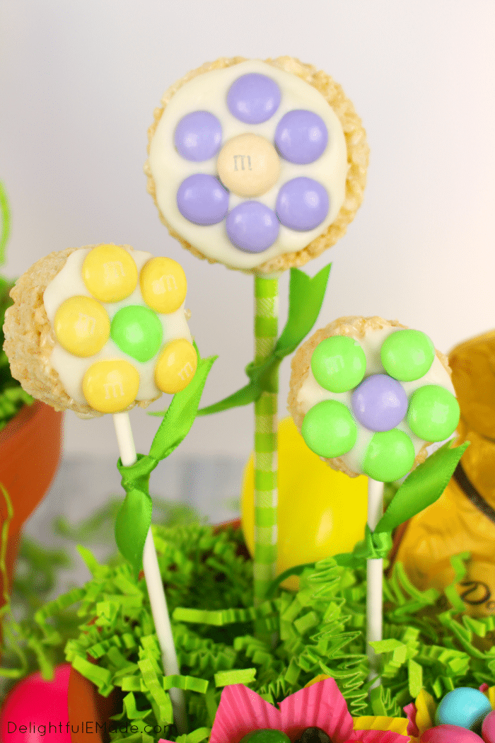 These colorful and fun M&M's® Spring Flower Pops are the perfect addition to any Easter basket. Made out of simple cereal treats, and decorated with white chocolate, and M&M's® candies, these also make for a fun spring treat for everyone you know!
