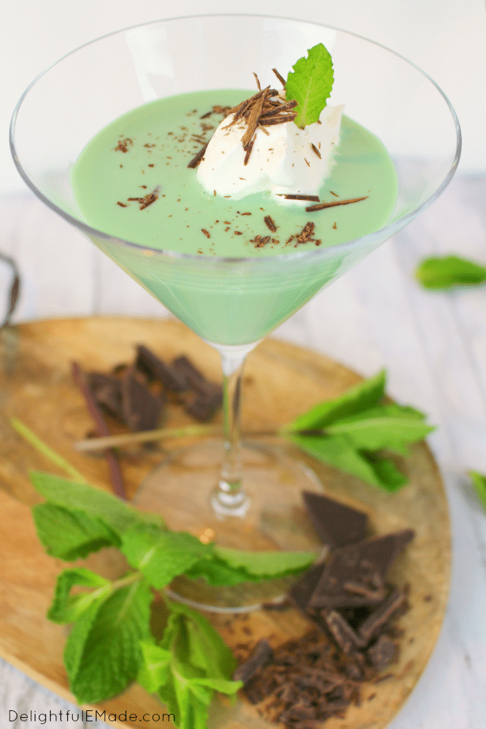 Mint chocolate martini in glass with chocolate shavings and whipped cream.