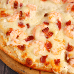 The ultimate pizza for Alfredo lovers! Loaded with tender shrimp, crisp bacon and lots of cheese, this pizza is the perfect way to enjoy all your favorite flavors on one delicious slice!