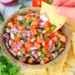 A must-have condiment for any Tex-Mex meal! This fresh, delicious Pico de Gallo Salsa is perfect for burritos, nachos, enchiladas, tacos, or anytime you want to enjoy chips and salsa! Forget the store-bought stuff, making a fresh batch is super simple and tastes way better!