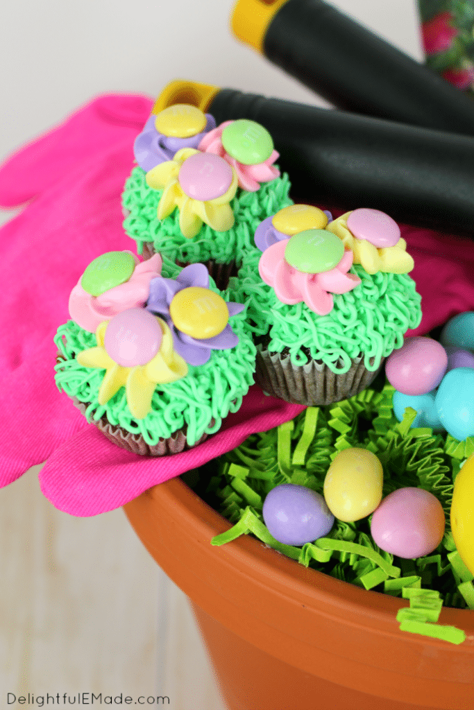 These fun, colorful cupcakes are the perfect mix of pretty pastel flowers, and delicious chocolate cake! Decorated with green grass frosting and topped with spring pansies adored with milk chocolate M&M's® Pastel candies, these cupcakes are perfect for Easter or any fun, spring occasion!