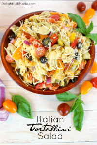 The perfect pasta salad for any pot-luck, picnic, cookout or backyard barbeque! This delicious tortellini salad is loaded with all of your Italian favorites, like tomatoes, olives, banana peppers, red onion, and topped with Italian dressing and shredded Parmesan cheese! The ultimate side dish for any meal!