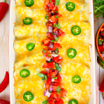 The only enchilada recipe you'll ever need! Stuffed with seasoned ground beef and cheese, smothered with a thick, delicious sour cream sauce, topped with more cheese and baked to perfection, these enchiladas are incredible! Amazing with pico de gallo and all your favorite Tex-Mex fixings!