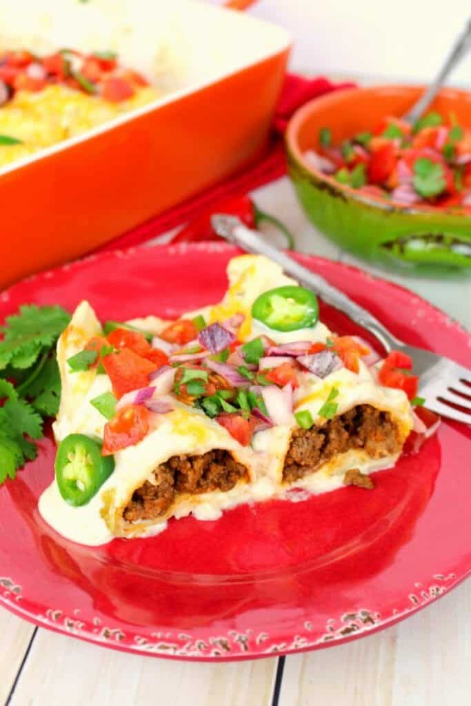 The best beef enchilada recipe on the internet!  Stuffed with seasoned ground beef and cheese, smothered with a delicious sour cream sauce, topped with more cheese and baked to perfection. These Beef Sour Cream Enchiladas are incredible!