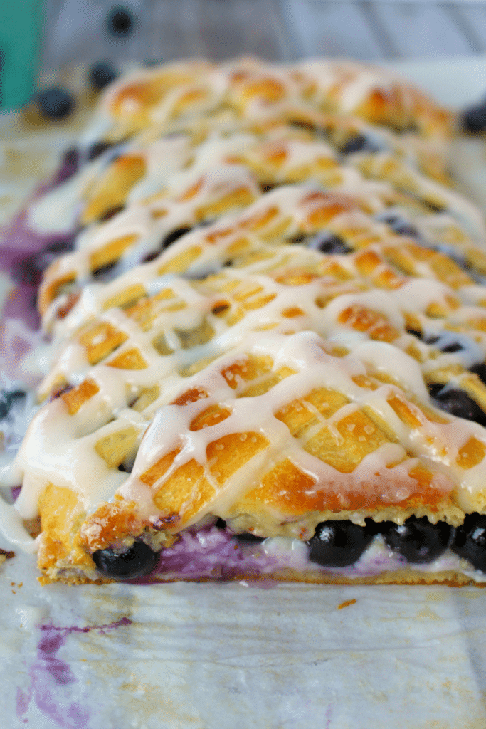 Meet your new favorite breakfast pastry! This super-simple Blueberry Cream Cheese Breakfast Braid is made from store-bought crescent sheets, along with fresh blueberries, and almonds and a baked to perfection. The perfect pairing with your morning coffee! 